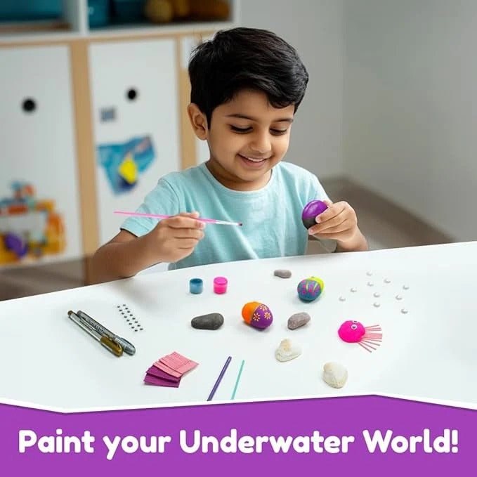 Child painting colorful underwater-themed stones with NIYO TOYS creative art kit