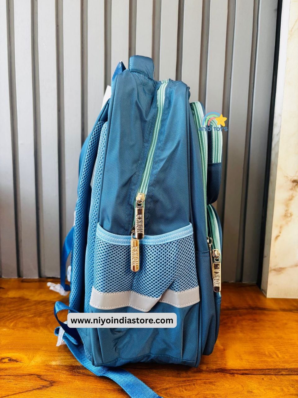 Side view of a green and blue backpack 16 inch featuring mesh pockets and durable zippers