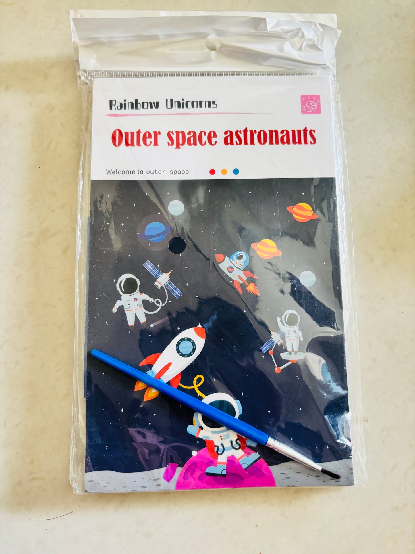 Magic water painting book for kids featuring outer space astronauts and colorful planets