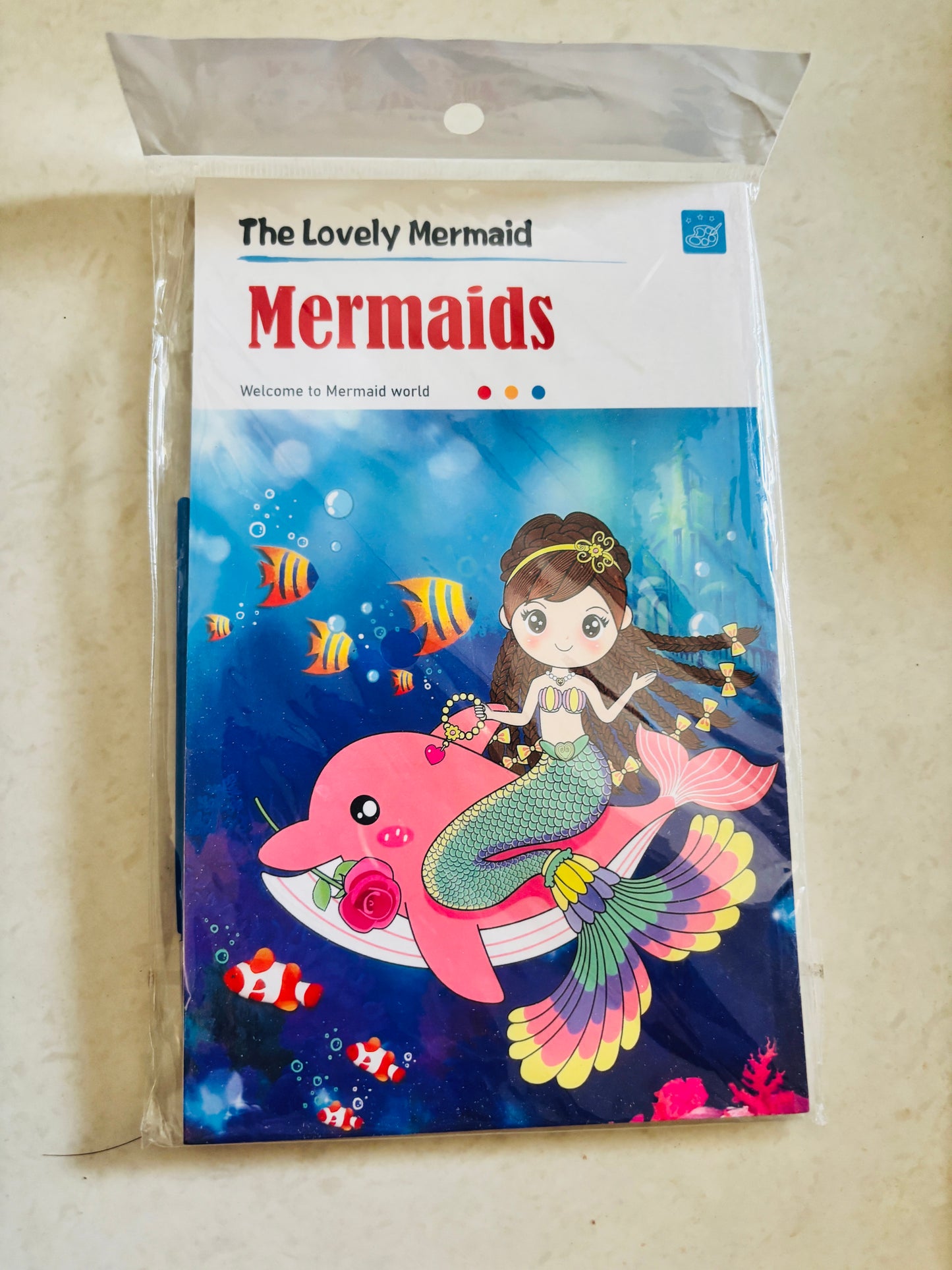 Magic water painting book for kids featuring a mermaid riding a dolphin with colorful sea life