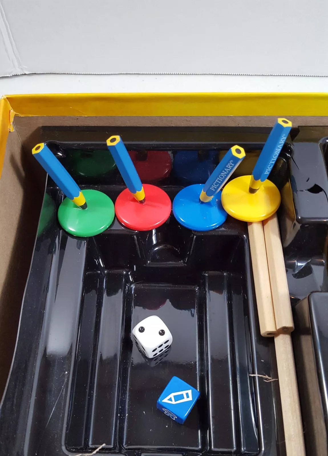 Contents of Niyo Toys Pictionary game for kids including colorful drawing accessories and dice