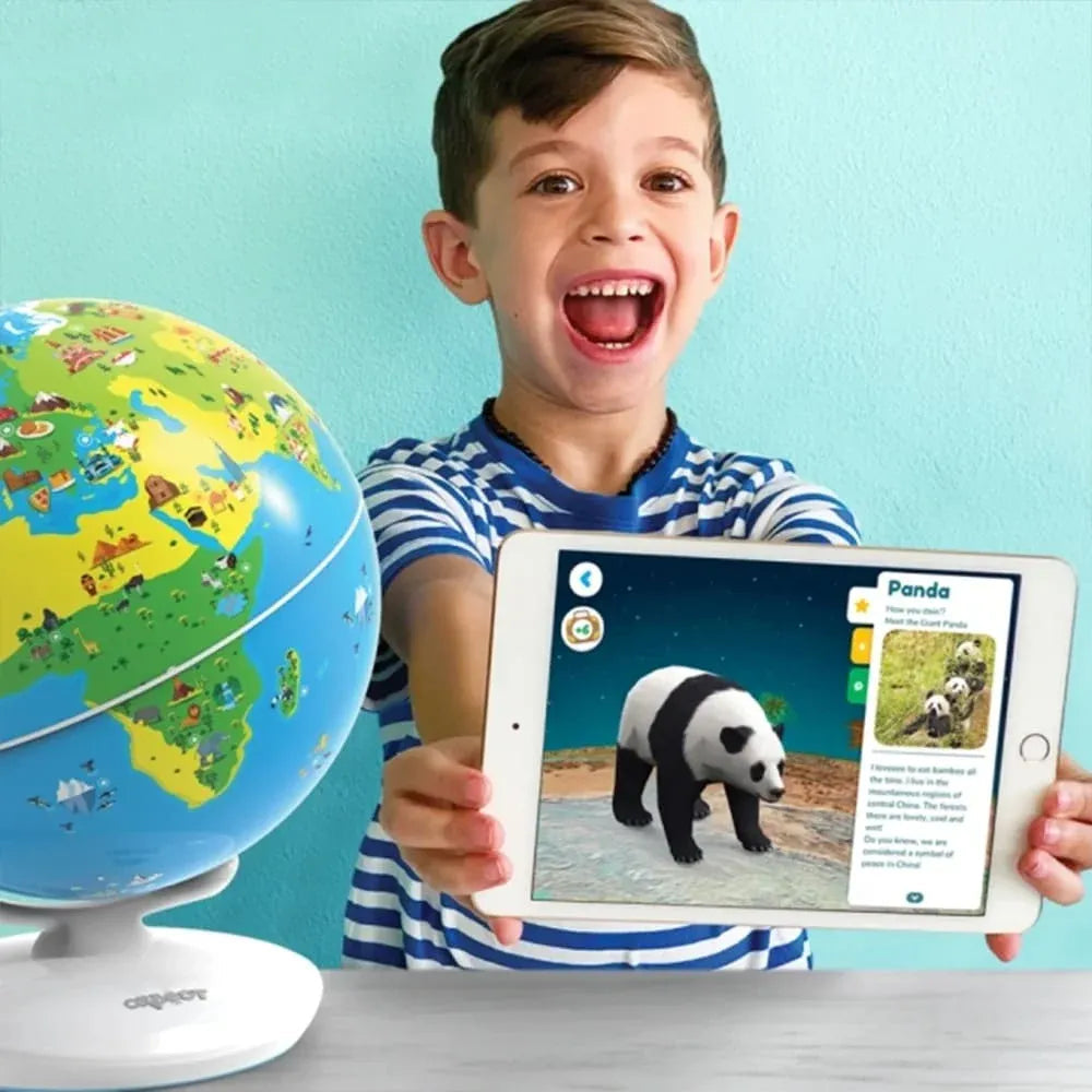 Excited boy holding tablet showing panda AR app next to colorful educational globe toy by NIYO TOYS