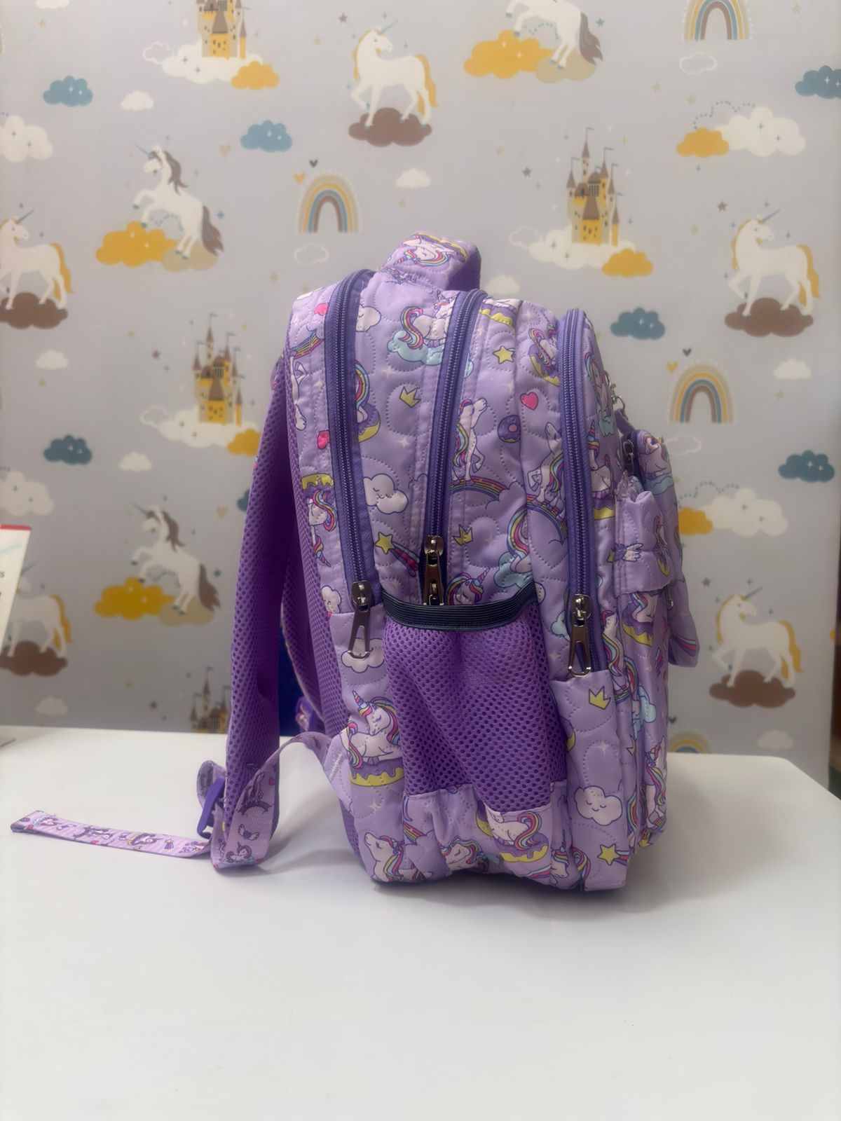Purple unicorn backpack with playful designs, ideal for ages 3 and up, perfect for school or outings