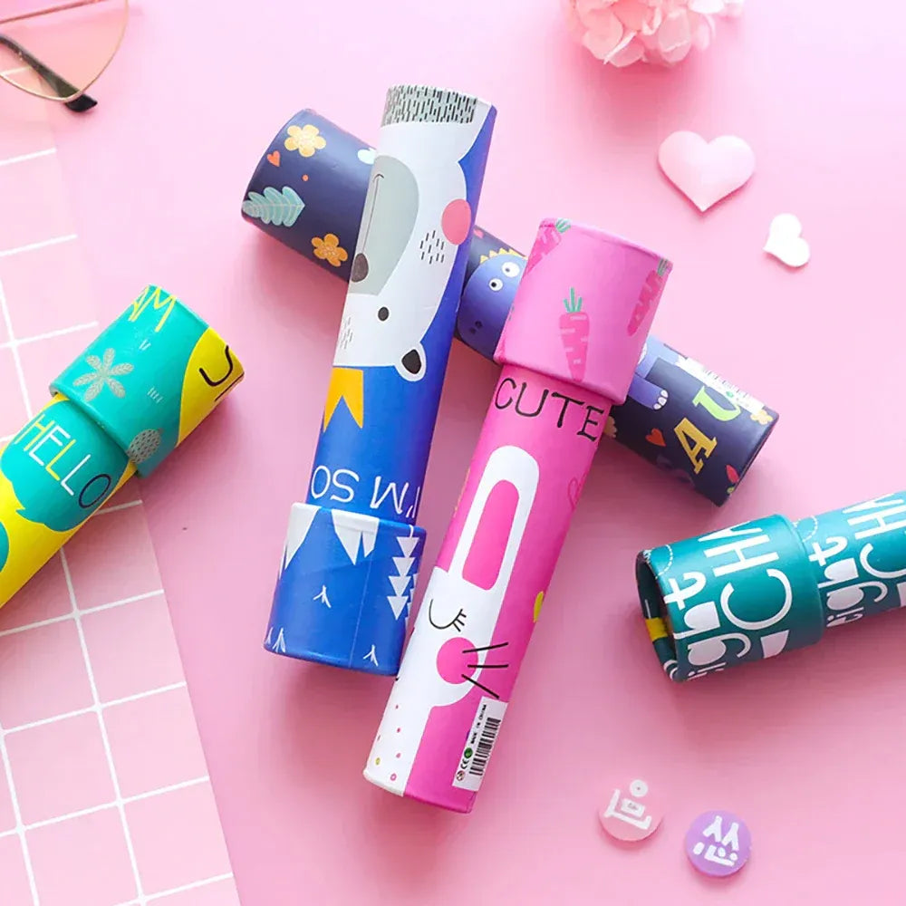 Colorful NIYO TOYS kaleidoscope tubes with animal and pattern designs on a pink background