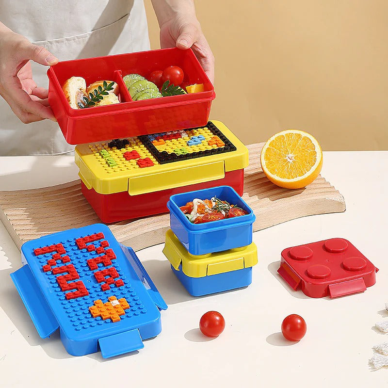 Colorful building blocks lunch box for kids, featuring stacking compartments and creative design for fun meals.