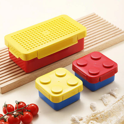 Building blocks lunch box for kids in red and yellow, ideal for school and outdoor meals