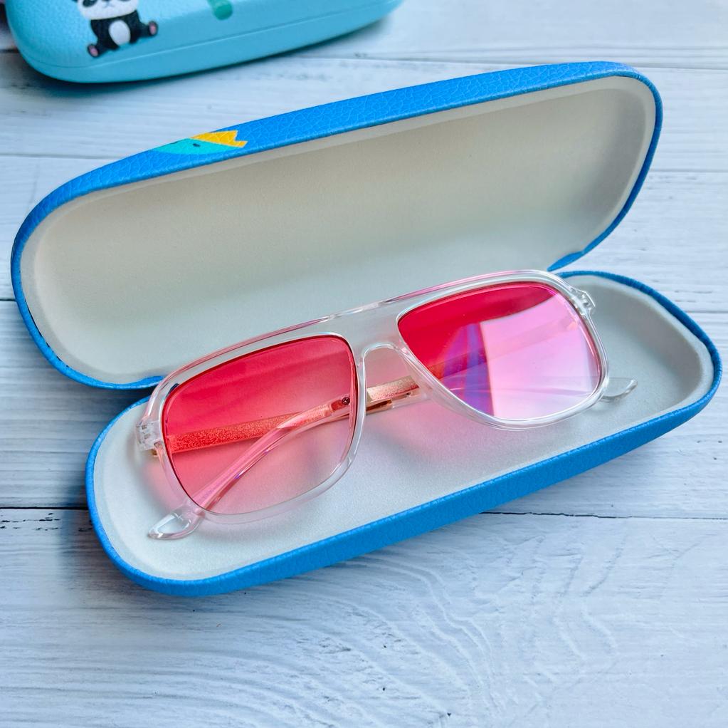 Clear sunglasses with pink lenses in a blue case eyewear, suitable for kids age 3+, for outdoor activities