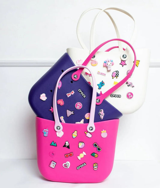 Colorful Crocs sippers in pink, purple, and white featuring fun stickers for kids ages 3 and up