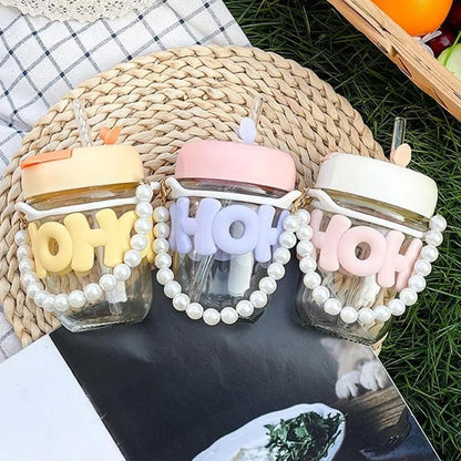 Cute glass tumbler with lid and straw in pastel colors for kids, perfect for parties and outdoor use