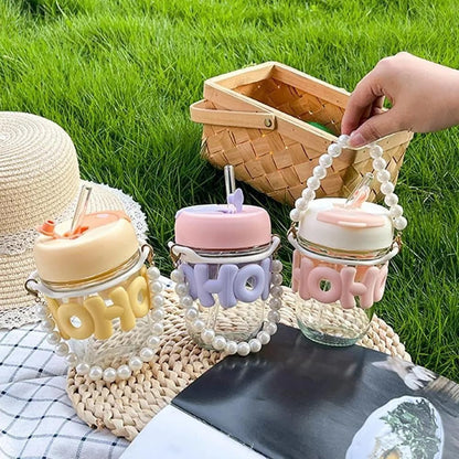 Cute glass tumbler with lid and straw in pastel colors, perfect for kids age 3 and up, ideal for drinks on the go