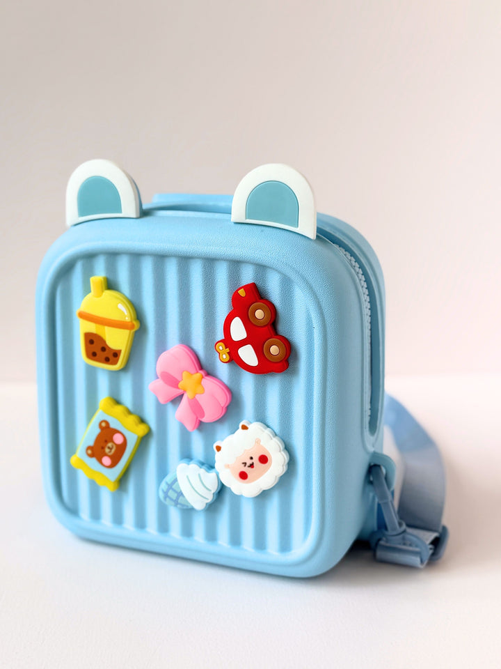 Cute kids backpack in light blue with fun 3D decorations, perfect for ages 3 and up