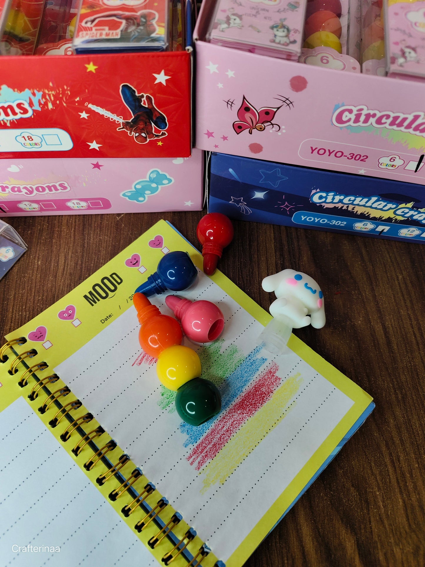 Colorful educational crayons for toddlers displayed on a notepad with a playful design