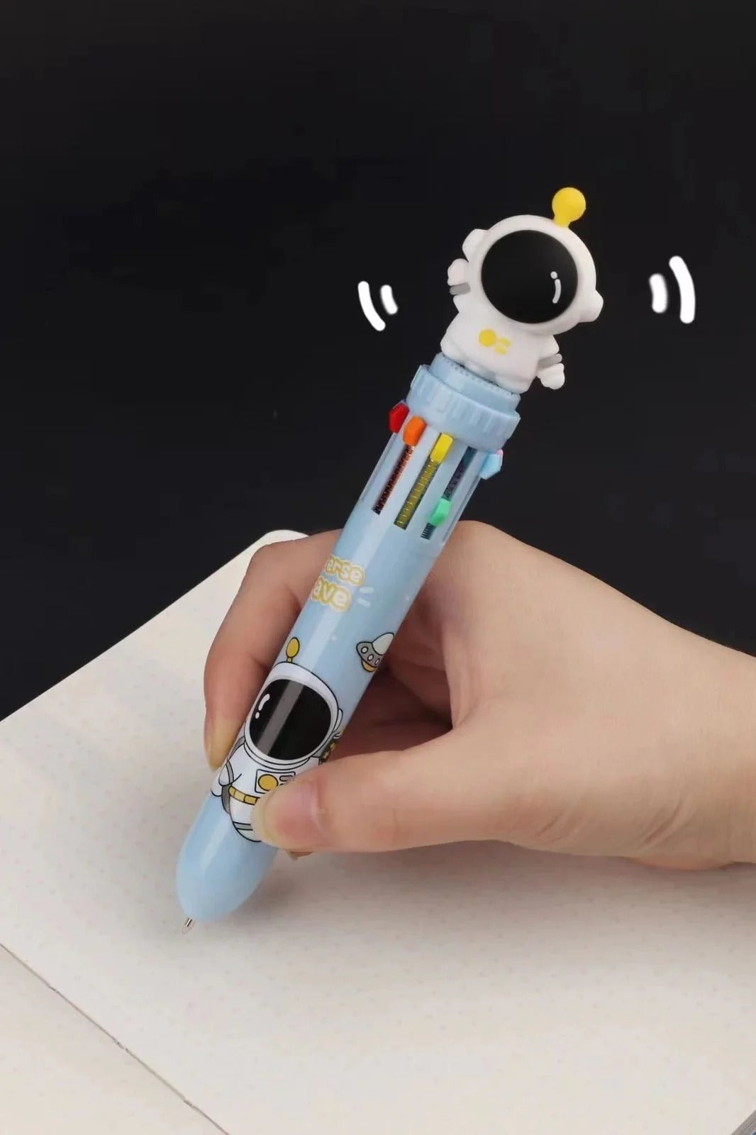 Light blue astronaut pen for kids featuring colorful sliders, inspired by fisher space pen company