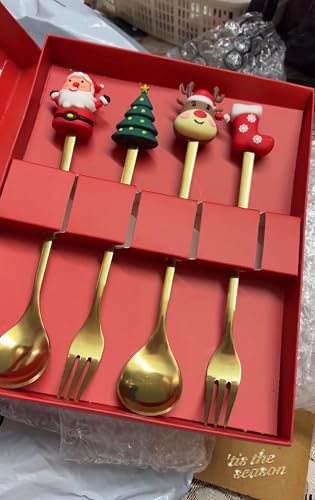 Gold-plated flatware set with festive holiday designs for kids, featuring Santa, a tree, a reindeer, and a stocking.