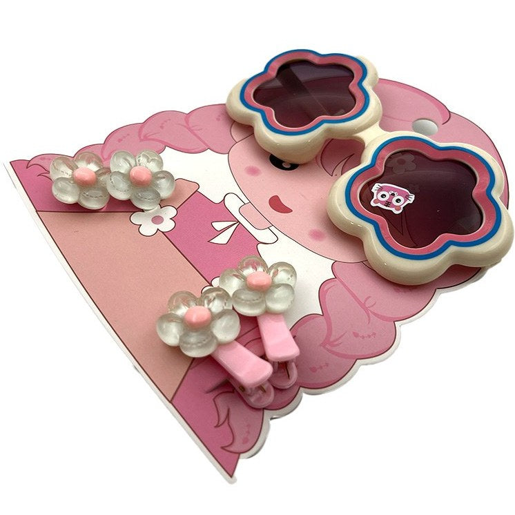 Flower-shaped sunglasses for kids with clip-in hair extensions in a colorful design