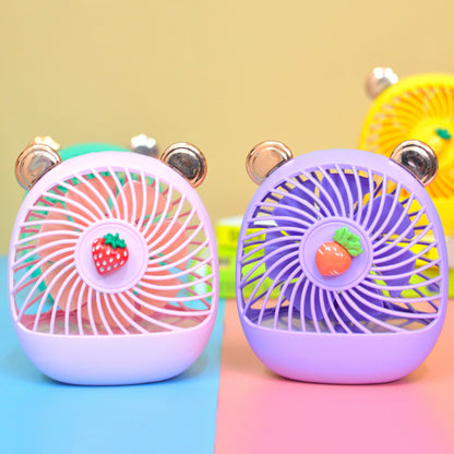 Colorful hand held fan in pink and purple with cute bear ears and fruit decorations for kids age 3 and up