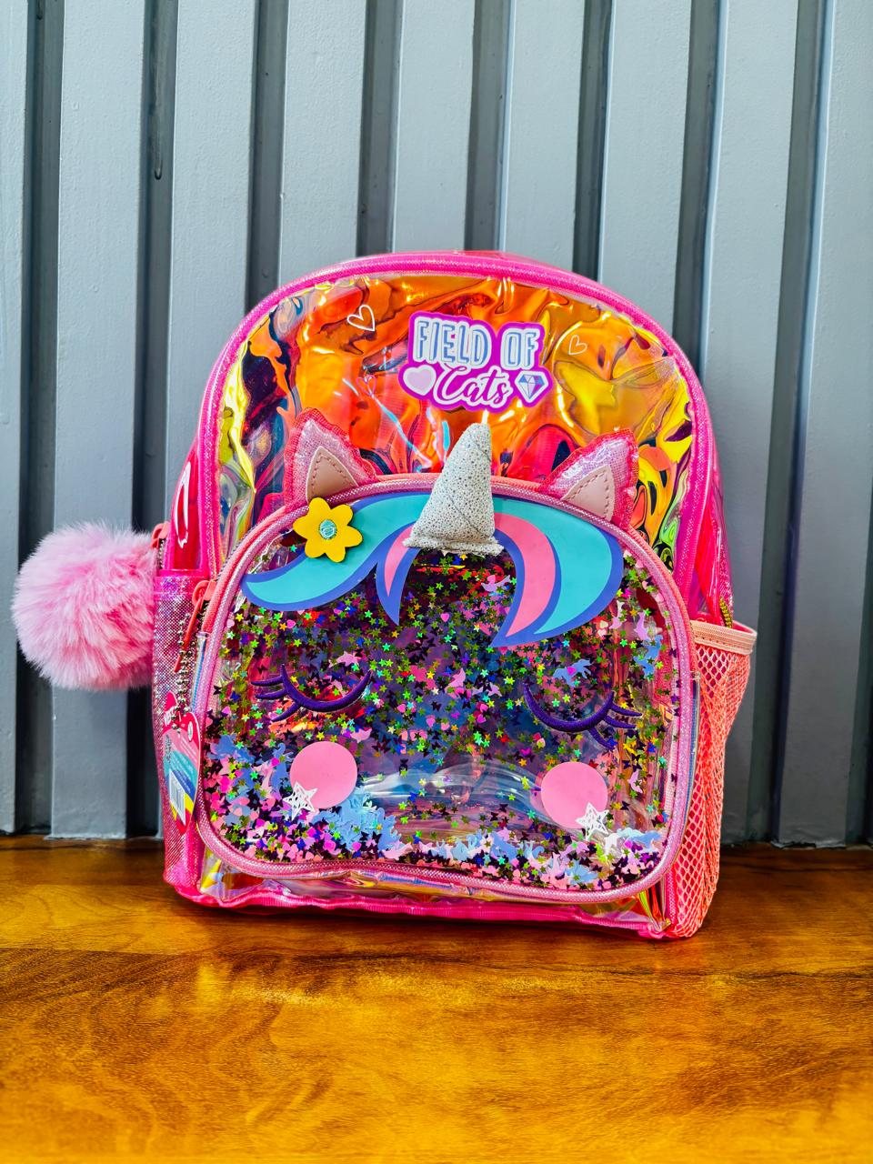 Colorful holographic unicorn bag for kids with glitter and a fluffy pom-pom on the zipper