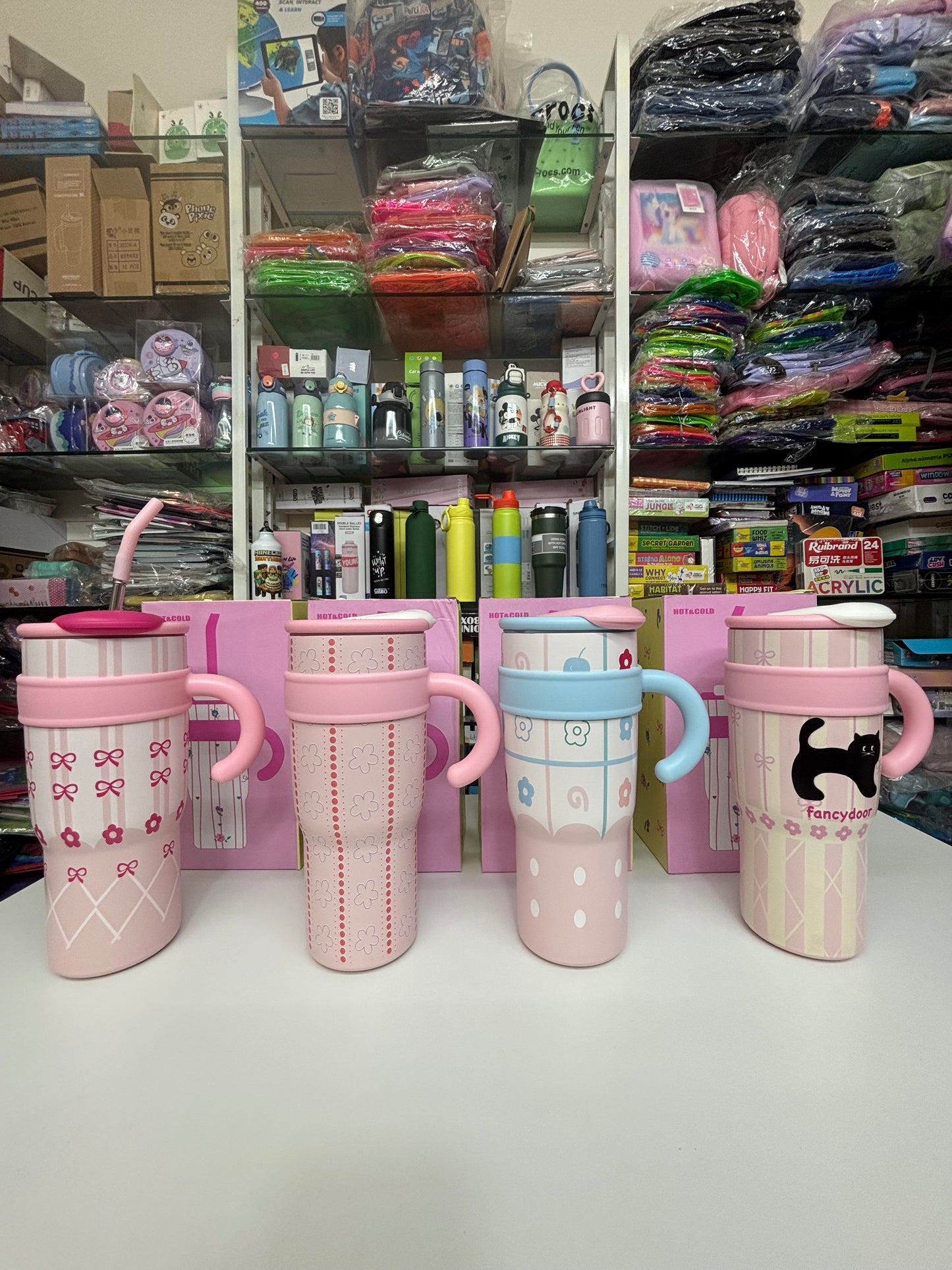Set of four pink insulated coffee mugs with fun patterns, ideal for kids aged 3 and up, perfect for beverages