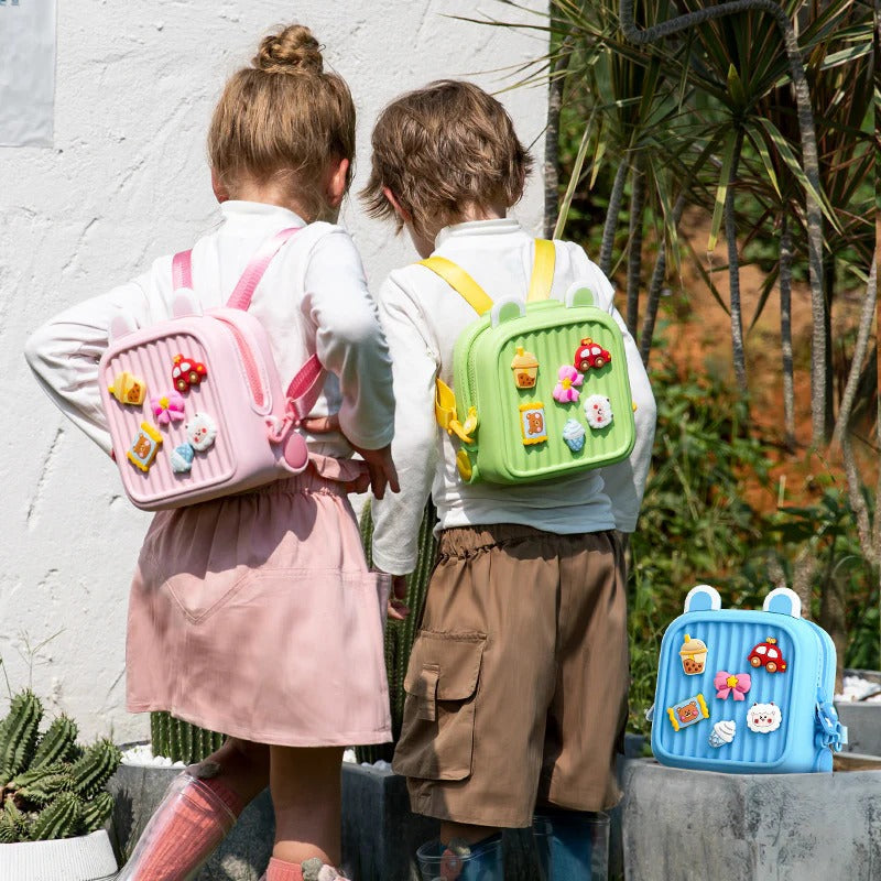 Two kids wearing NIYO TOYS cute kids mini backpacks in pastel colors with fun decorations