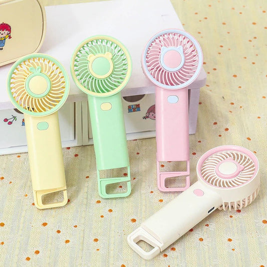 Colorful NIYO TOYS rechargeable fan in pink, green, and yellow, perfect for kids aged 3 and up