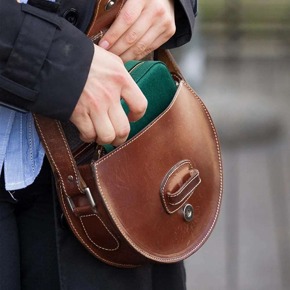 Brown leather jewelry case for travel, ideal for organizing accessories on the go