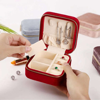 Red velvet jewelry case for travel with compartments for earrings and rings, ideal for organized packing