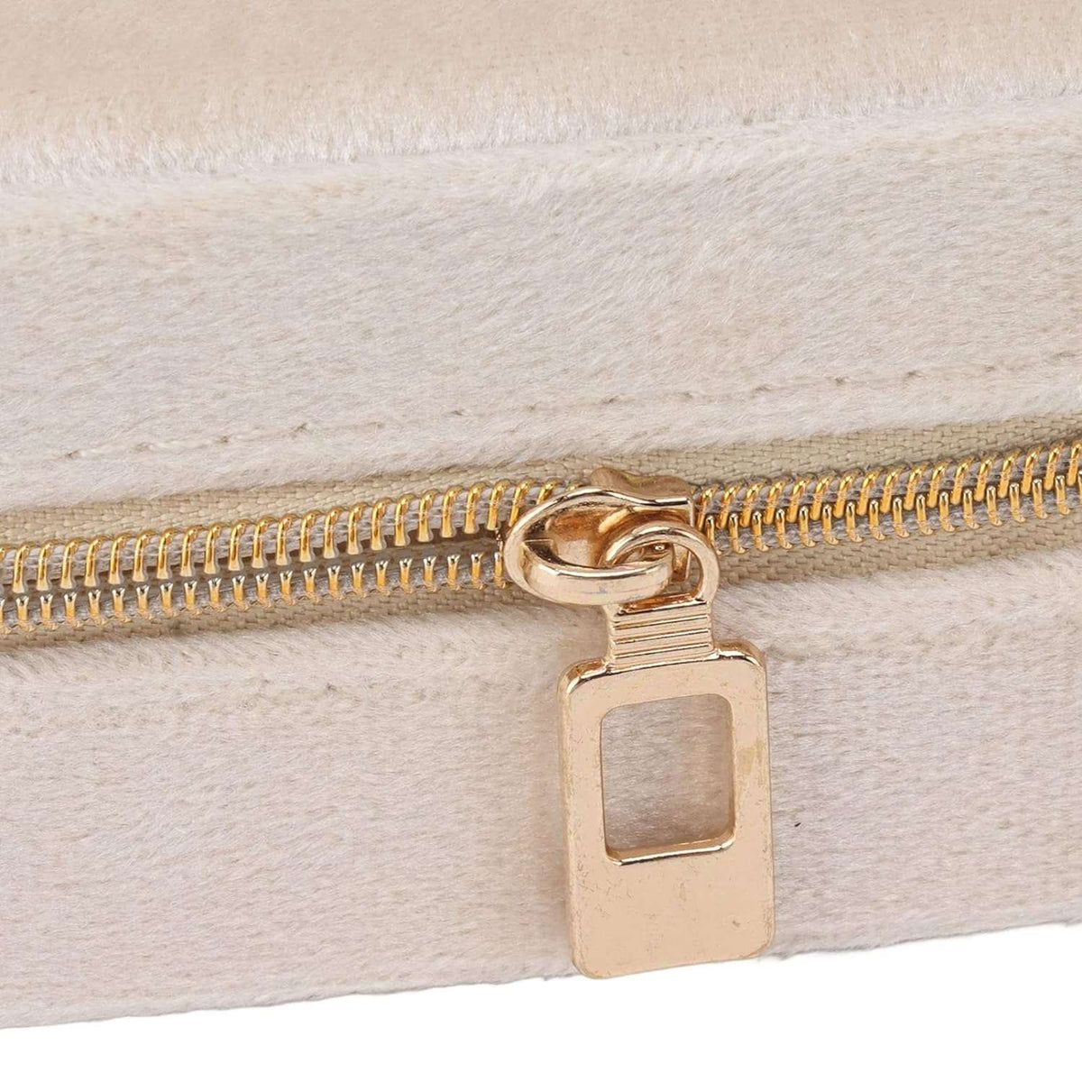 Beige jewelry case for travel with a gold zipper, perfect for organizing accessories on the go