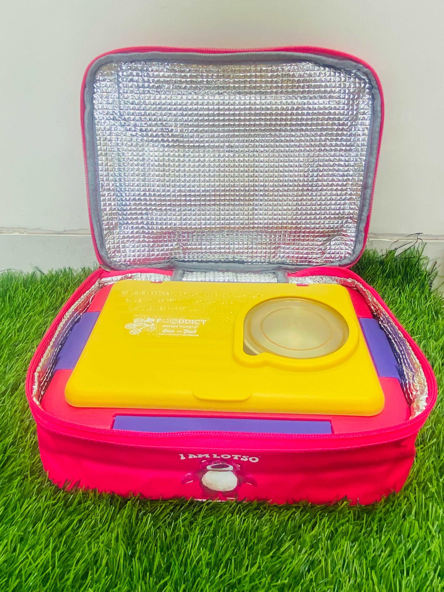 NIYO TOYS kids insulated lunch bag in pink, open with a yellow lunch container inside