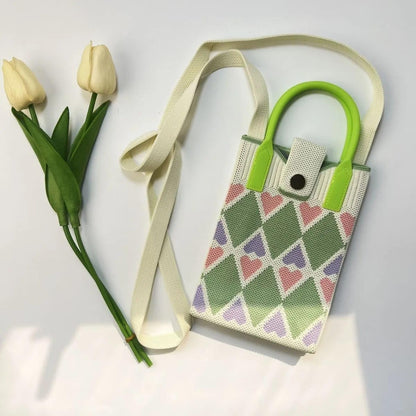 Colorful NIYO TOYS sling bag with heart patterns, perfect for kids and stylish outings, features a leather crossbody mini bag
