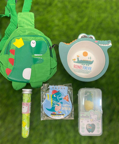 NIYO TOYS rakhi hamper featuring a green dinosaur backpack, bowl, notebooks, and fun accessories for kids