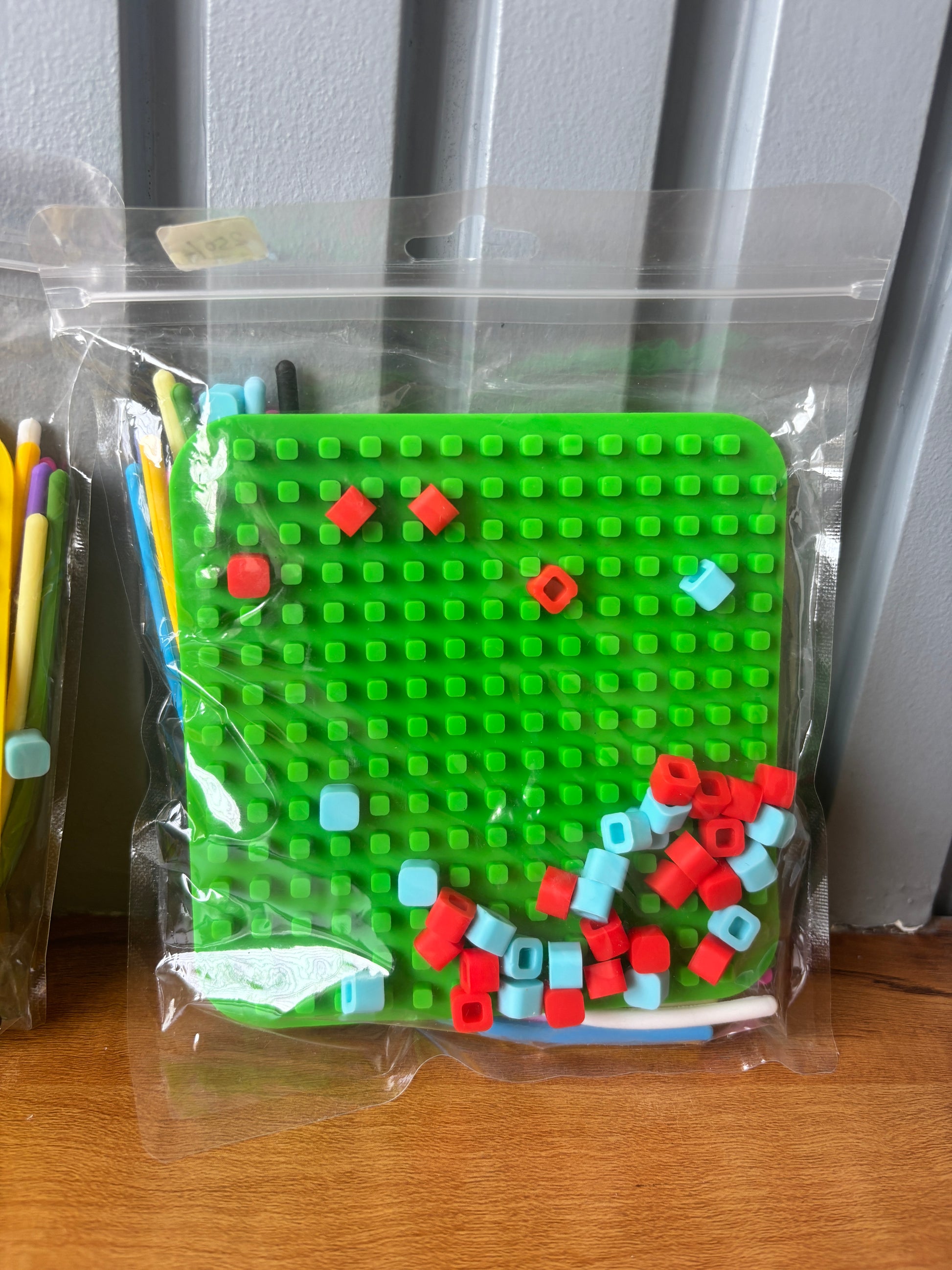 Green sensory fidget toy puzzle set with colorful building blocks, age 3+, great for developing fine motor skills