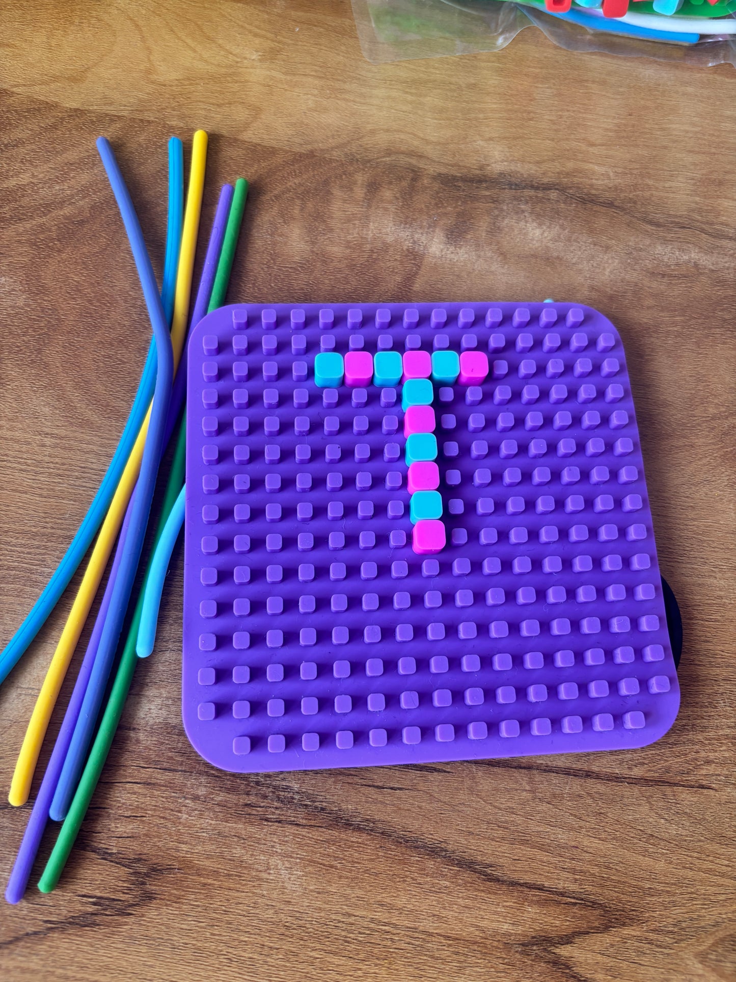 Purple sensory fidget toy puzzle with colorful sticks, suitable for ages 3 and up, ideal for play and stress relief