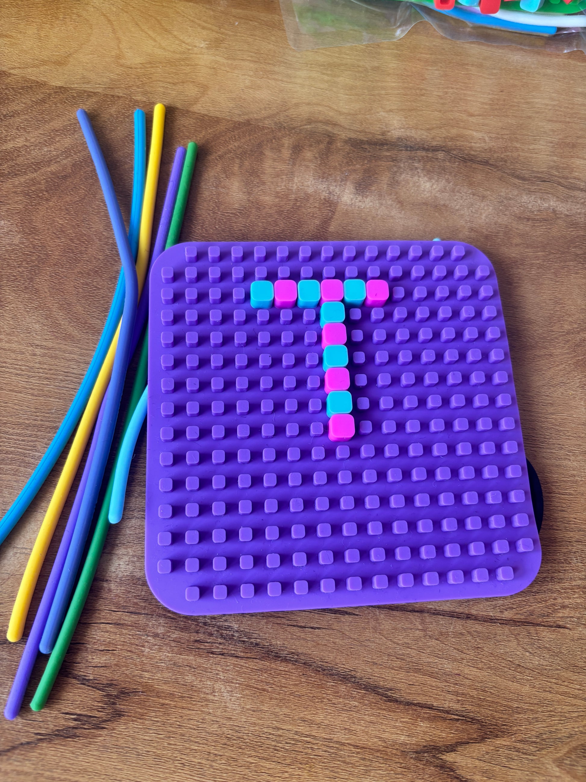 Purple sensory fidget toy puzzle with colorful sticks, suitable for ages 3 and up, ideal for play and stress relief