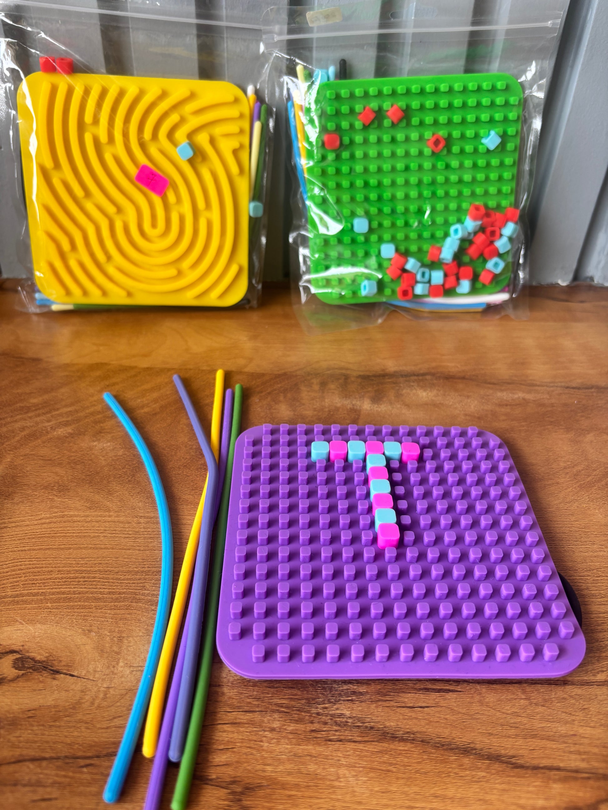 NIYO TOYS sensory fidget toy in purple, green, and yellow, ideal for ages 3+, promotes tactile play