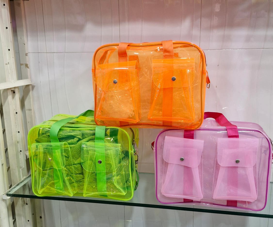 Colorful transparent neon tote bag collection in orange, green, and pink with multiple pockets