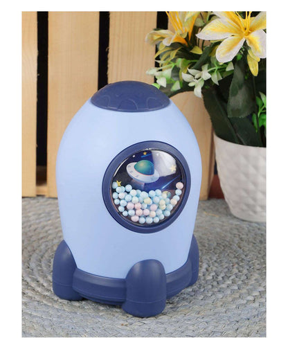 Blue rocket-shaped piggy bank for ages 3+, featuring colorful beads inside, inspired by varo bank high-yield savings account