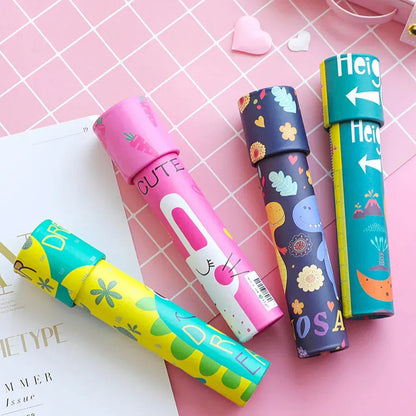 Colorful NIYO TOYS kaleidoscope toys with animal and floral designs on a pink grid background